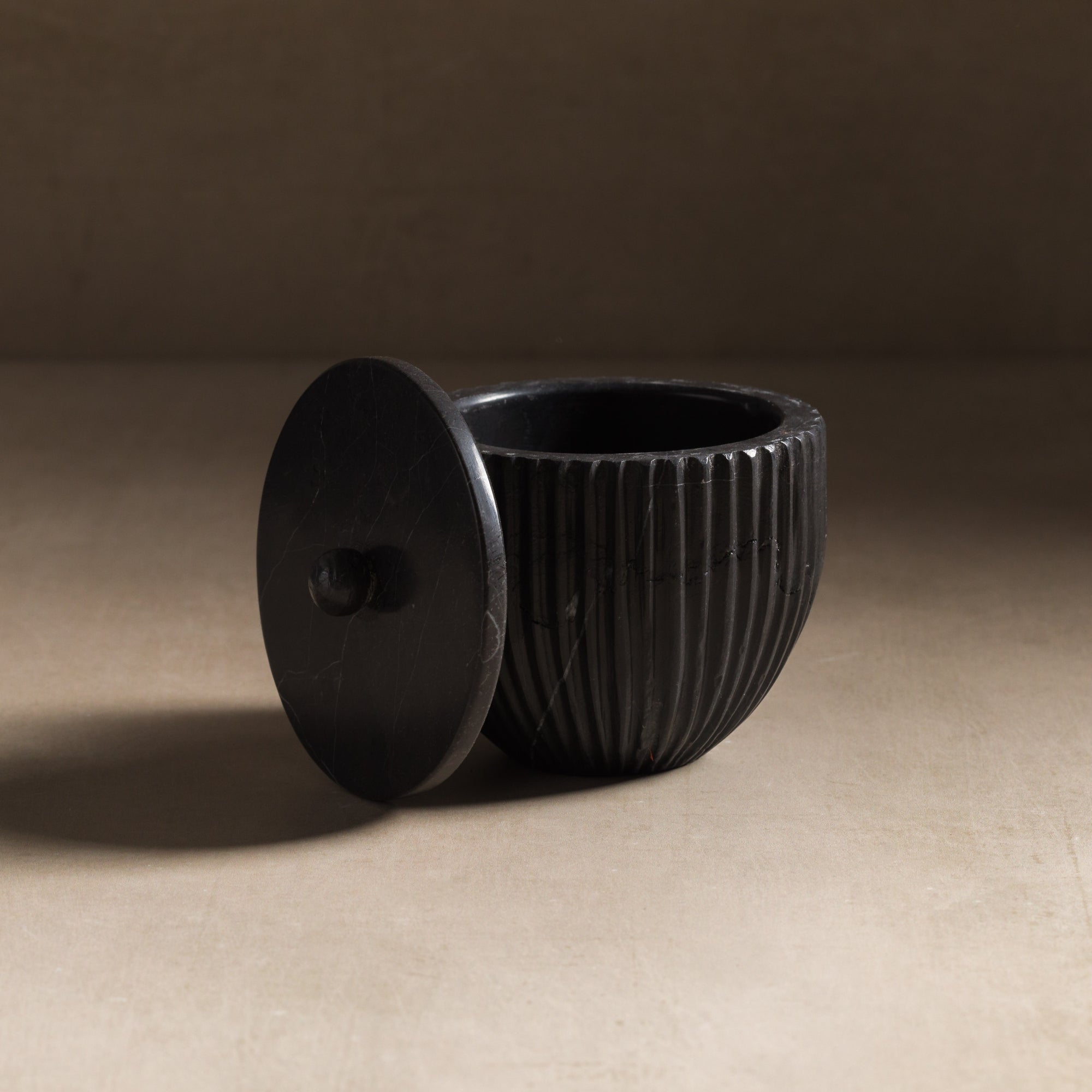 Small container for bathroom made of black marble