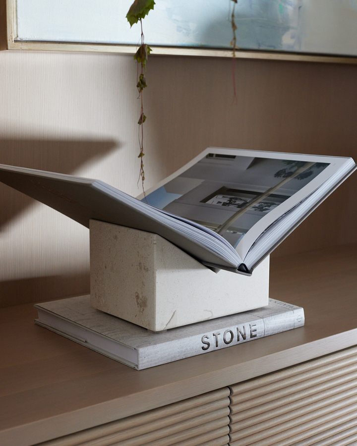 Muse Stone Bookstand made from Limestone displaying a design book