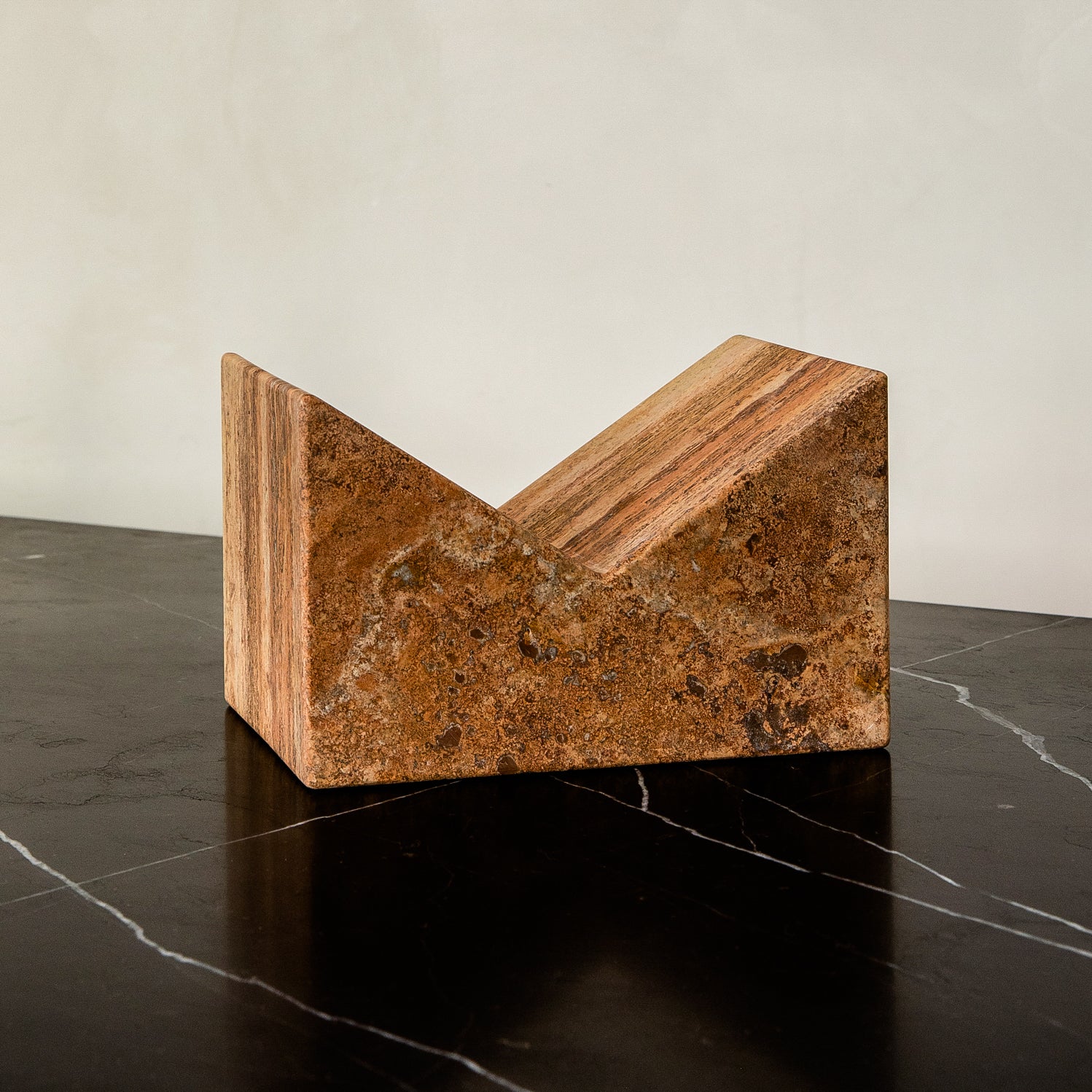 Bookstand holder made from travertine stone.