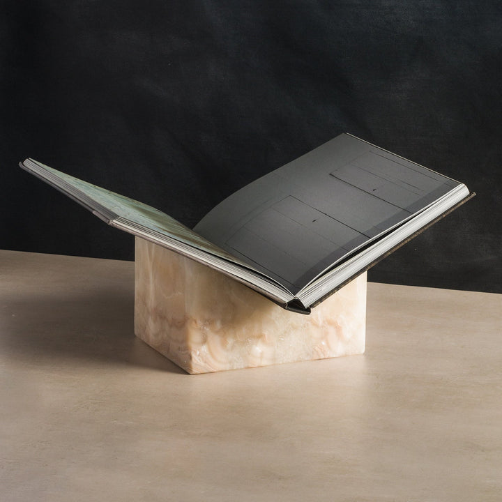 Open faced book being displayed on a luxury stone bookstand