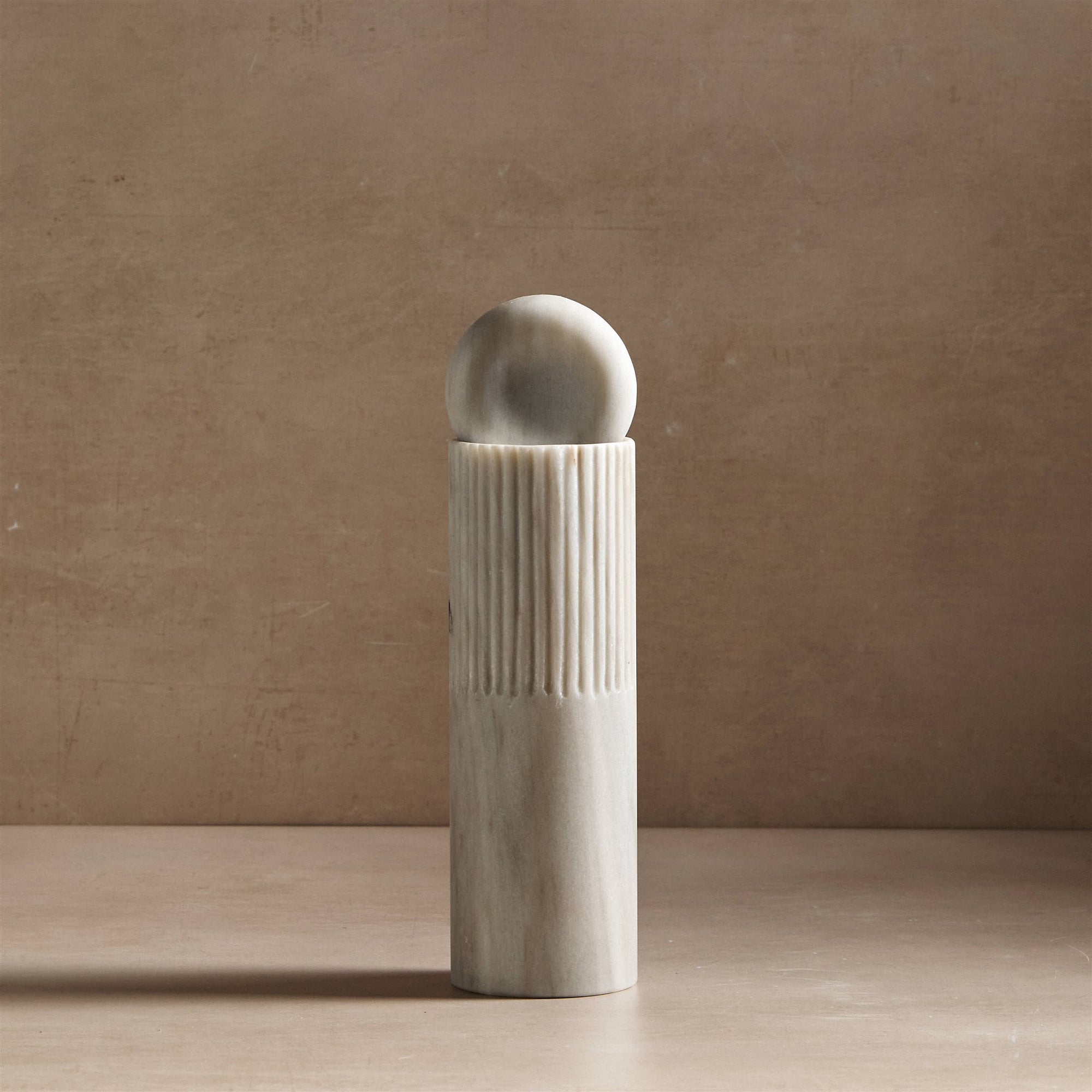 small totem sculpture made of white marble for decor