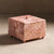 Pink marble square box with lid and ribbing details.