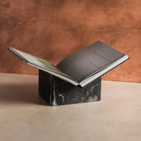 Bookstand holder made from black marble displaying a book