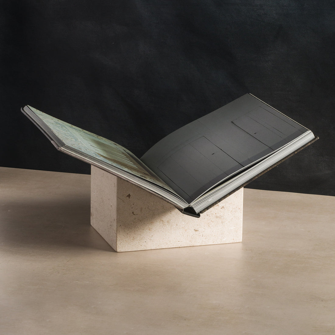 Bookstand holder made from cream limestone displaying a book