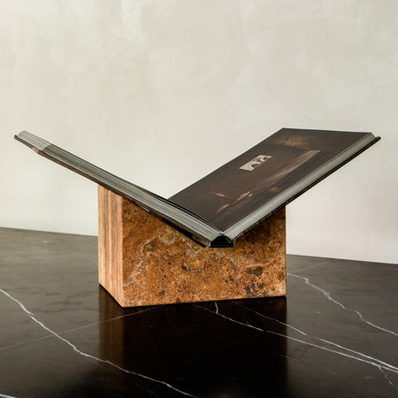 Bookstand holder made from travertine stone displaying a book.
