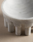 Details of round curves on white marble stone bowl with feet