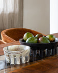 decorative stone bowls holding mangos on a dining table