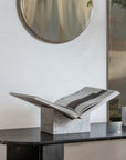 Luxury white marble stone bookstand displayed on a black marble console table