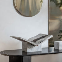 Luxury white marble stone bookstand displayed on a black marble console table