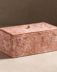 Stone box with ribbing on the sides and made from pink marble