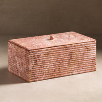 Stone box with ribbing on the sides and made from pink marble