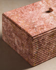 Ribbing detail on a stone box made of pink marble