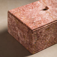 Ribbing detail on a stone box made of pink marble