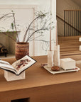 Stone decor and accessories displayed on a coffee table made of light wood.