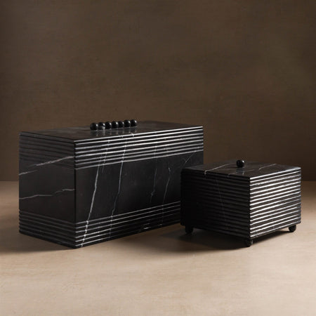 Black box with ribbing detail made from black marble.