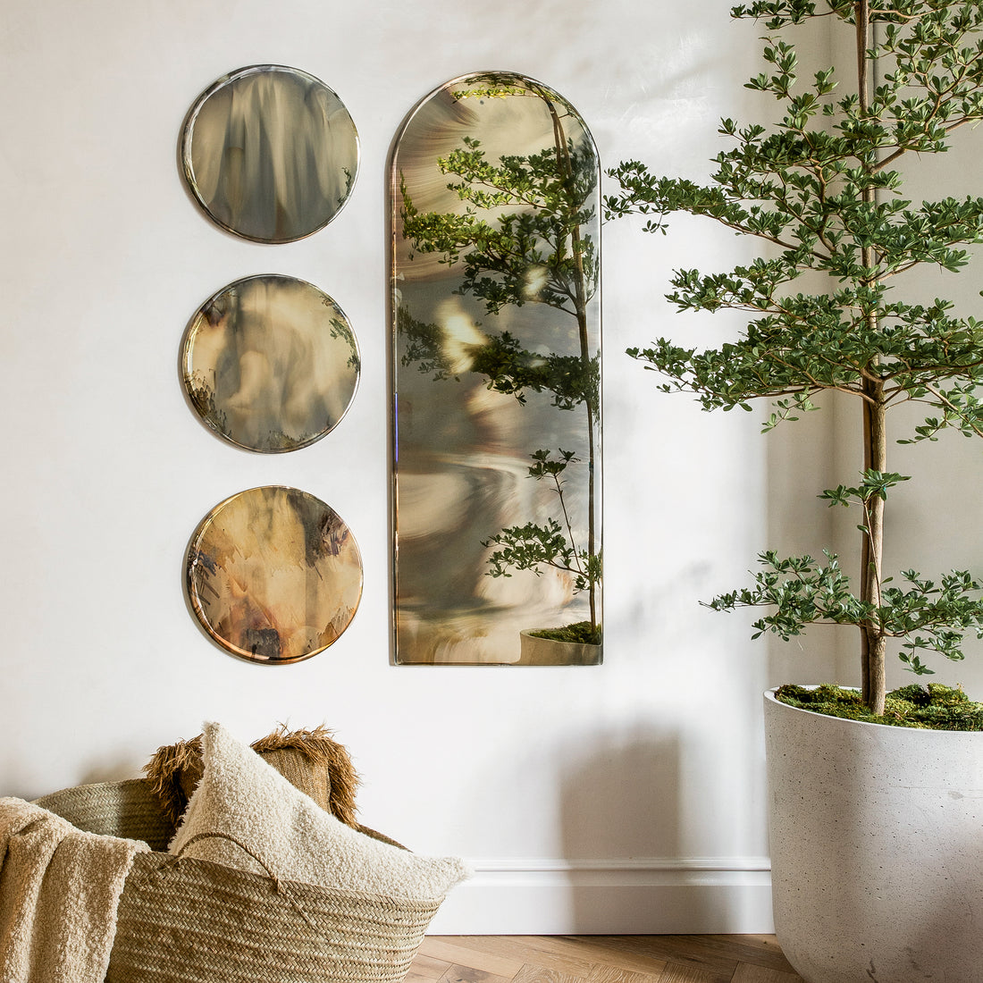 Antiqued mirrors hanging on a plastered wall.
