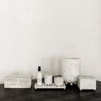 Collection of white marble decor and home accessories.